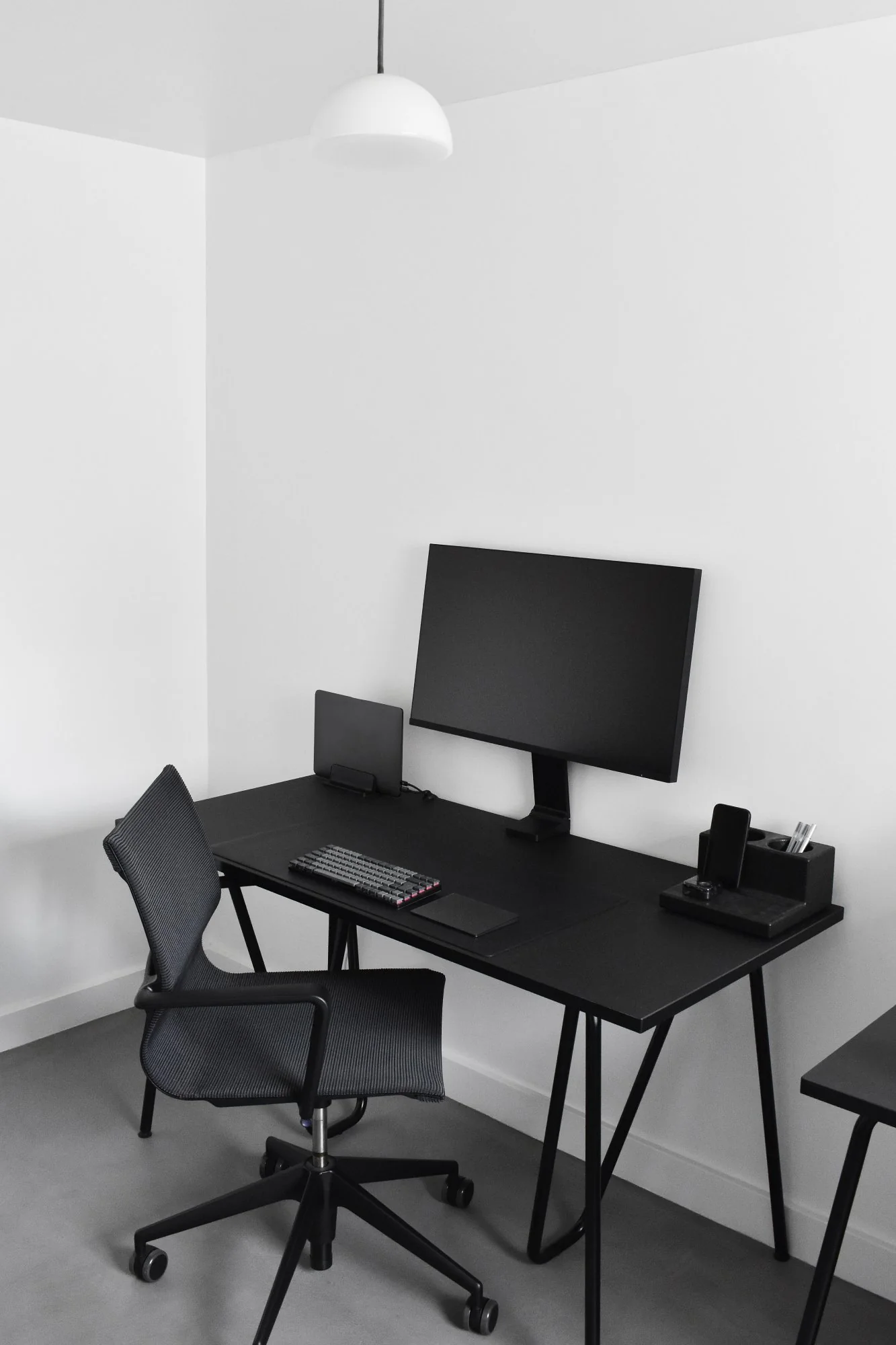 Organised home office setup with laptop, monitor and notebook for hybrid work productivity